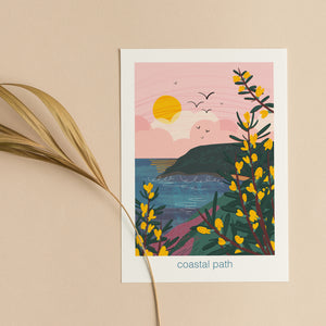 Greeting card with a coastal path illustration with gorse flowering, the sea and a pink sky and cliffs in the background