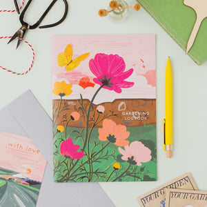 A flat lay with the gardening logbook, part of a collection of paper goods for gardeners, allotment lovers and people who love to grow things.