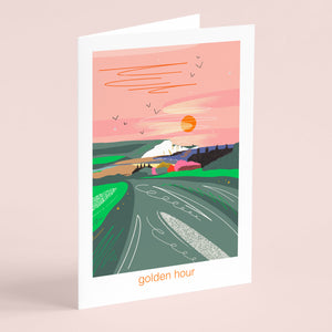 Greeting card with a colorful illustration of a landscape and 'golden hour' text, illustrated nature card by onneke