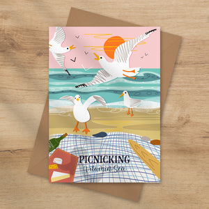 Coastal greeting card with seagulls and picnic scene