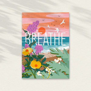 Colourful illustration with 'BREATHE' text with the sea in the background, seagulls flying over and seakale and wild flowers in the foreground. A mindful greeting card illustrated by onneke