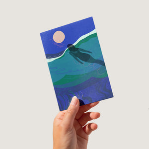 Full moon sea swimming card with swimmer swimming up towards the rising moon