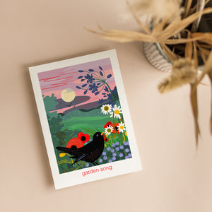 Greeting card with a colorful illustration of birds and flowers in a garden with full moon rising. A nature card with illustration by onneke