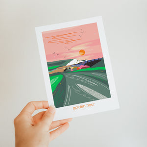 Illustrated poster of a sunrise over a path with the seven sisters cliffs in the background and the coastguard cottages by cuckmere haven, illustrated coastal card by onneke