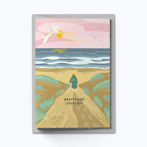 Gratitude logbook cover with a scenic illustration of a person walking on a path by the sea.
