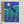 A square illustrated calendar titled 'Luna calendar 2027' leaning against a textured off-white wall. The design features a dark blue night sky with a large pale moon, teal and green wave-like forms, and rows of monthly date blocks with moon phase graphics.