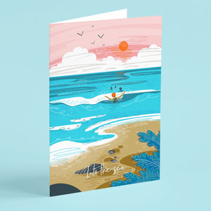 Illustrated greeting card with a beach scene, people swimming, and a pink sky with clouds and sun.