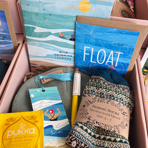 All the wild swimming items in a beautiful light pink gift box
