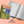 Running logbook with a colorful cover and open pages on a peach background, featuring 'Gift of the Year' finalist logo.