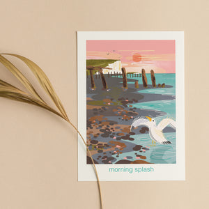 Greeting card with a seagull in the shoreline, a pebble beach and cliffs in the background. Nature illustration on coastal card by onneke