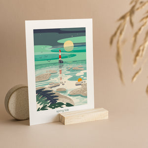 Lighthouse in the sea with the tide going out and the full moon rising